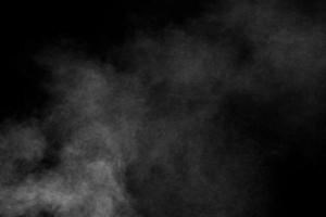 White dust cloud in the air.Abstract white powder explosion against black background. photo