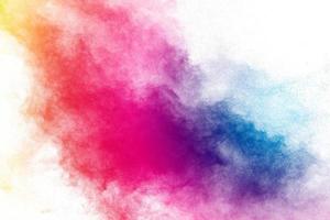 Freeze motion of color powder exploding on white background. photo