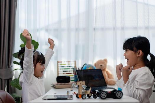 Asia students learn at home in coding robot cars and electronic board cables in STEM, STEAM, mathematics engineering science technology computer code in robotics for kids concept. photo