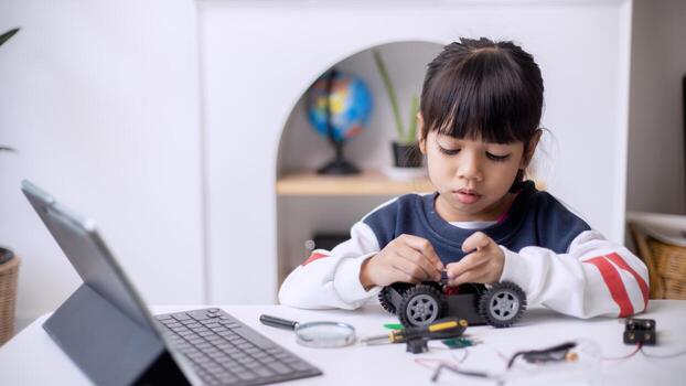 Asia students learn at home in coding robot cars and electronic board cables in STEM, STEAM, mathematics engineering science technology computer code in robotics for kids concept photo