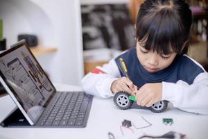 Asia students learn at home in coding robot cars and electronic board cables in STEM, STEAM, mathematics engineering science technology computer code in robotics for kids concept photo