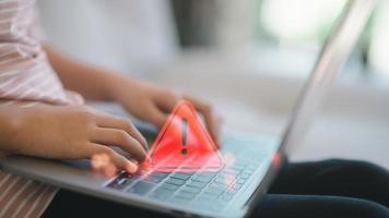 Computer notification error maintenance concept. programmer, or developer using a computer laptop with a triangle warning exclamation red sign trouble caution. photo