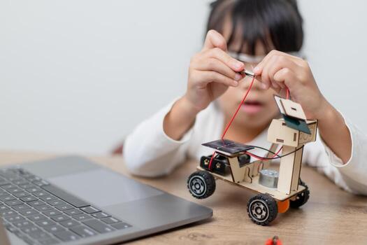Asia students learn at home in coding robot cars and electronic board cables in STEM, STEAM, mathematics engineering science technology computer code in robotics for kids concept. photo