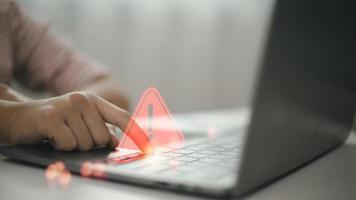 Computer notification error maintenance concept. programmer, or developer using a computer laptop with a triangle warning exclamation red sign trouble caution. photo