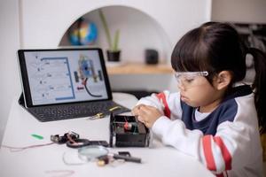 Asia students learn at home in coding robot cars and electronic board cables in STEM, STEAM, mathematics engineering science technology computer code in robotics for kids concept photo