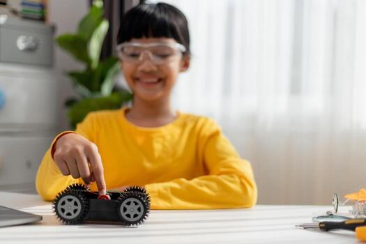 Asia students learn at home in coding robot cars and electronic board cables in STEM, STEAM, mathematics engineering science technology computer code in robotics for kids concept. photo