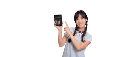 Portrait of beautiful young asian woman in denim dress holding calculator on white background. business shopping online concept. photo