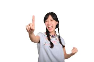 Portrait of beautiful happy young asian woman in denim dress touching invisible screen on white background. photo