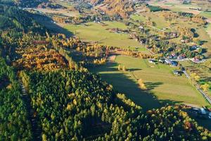 Mountain village and agricultural fields, aerial view. Nature landscape photo