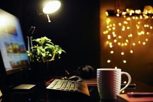 Workplace with computer at night photo