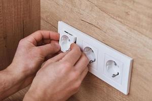 Electrician installing socket in the kitchen photo