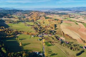 Mountain village and agricultural fields, aerial view. Nature landscape photo