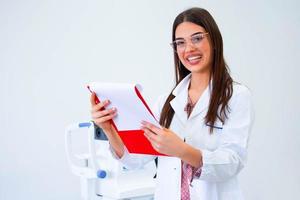 smiling ophthalmologist standing with diagnosis in clinic. photo