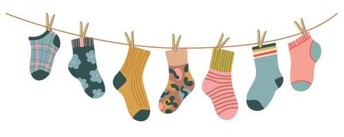 Socks on rope. Cotton or wool sock dry and hang on laundry string with clothespins. Children socks with textures and patterns vector cartoon. Illustration wool and cotton socks in rope