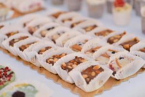 delicious sweets arranged on the table for wedding reception photo