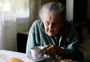 Elderly lonely woman photo