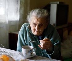 Elderly lonely woman photo