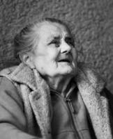 Very old and tired wrinkled woman outdoors photo