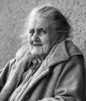 Very old and tired wrinkled woman outdoors photo