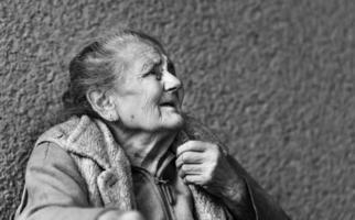 Very old and tired wrinkled woman outdoors photo