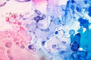 Blue pink and purple ink drops and splotches background photo