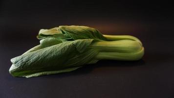 Fresh Bok choy vegetable on black background. photo