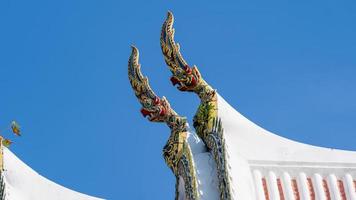 gable apex on the Buddhist temple with blue sky photo