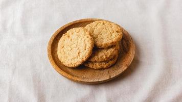 Oatmeal cookies on a wooden plate photo