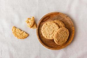 Oatmeal cookies on a wooden plate photo