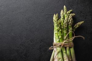 Green asparagus on a black background photo