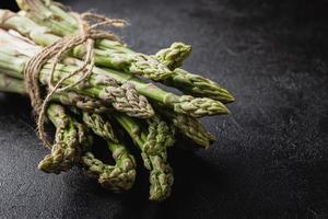 Green asparagus on a black background photo