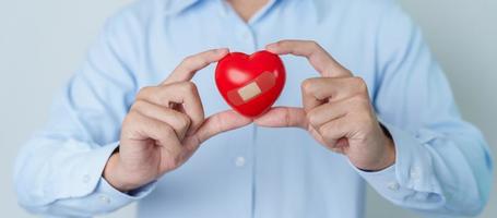 man hand holding red heart shape. love, donor, world heart day, world health day and Insurance concepts photo