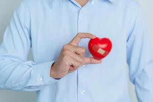 man hand holding red heart shape. love, donor, world heart day, world health day and Insurance concepts photo