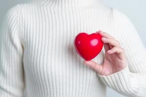 woman hand holding red heart shape. love, donor, world heart day, world health day and Insurance concepts photo