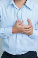 man hand holding chest ache. Heart disease, angina disease and symptom heart attack disease Cardiovascular, Atherosclerosis, Hypertensive world Heart day and health concept photo