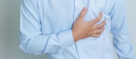 man hand holding chest ache. Heart disease, angina disease and symptom heart attack disease Cardiovascular, Atherosclerosis, Hypertensive world Heart day and health concept photo