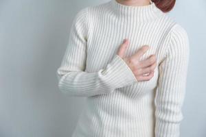 woman hand holding chest ache. Heart disease, angina disease and symptom heart attack disease Cardiovascular, Atherosclerosis, Hypertensive world Heart day and health concept photo
