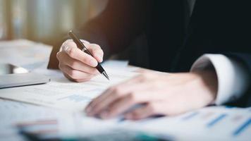 Business people read business statistics chart reports, to analyze and improve corporate strategy, manage financial and marketing documents, update annual budget accounts, company growth data. photo