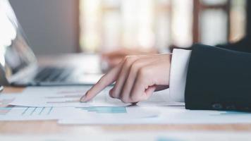 Business people read business statistics chart reports, to analyze and improve corporate strategy, manage financial and marketing documents, update annual budget accounts, company growth data. photo