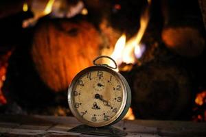 An old alarm clock on a wooden table photo