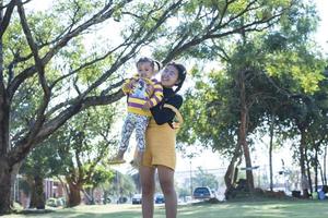 Asian family having fun in the garden Mother and daughter having fun together. photo