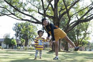 Asian family having fun in the garden Mother and daughter having fun together. photo