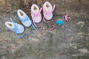 2023 new year written laces of children's shoes and pacifier on old wooden background. Top view. Flat lay. Space for text. photo