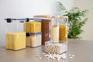 Containers for storing bulk products in the kitchen. Selective focus on a can of beans. photo