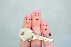 Fingers art of happy couple. Family holds house key. photo