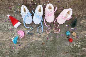 2023 new year written laces of children's shoes and pacifier on old wooden background. Top view. Flat lay. photo