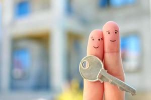 dedos arte de pareja feliz. la familia tiene la llave de la casa. foto