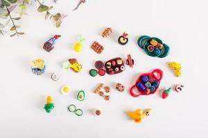 Handmade food set made of polymer clay on a light background. Children's leisure. Top view photo