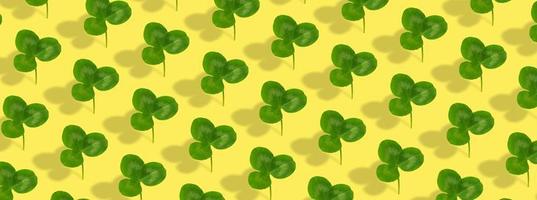 Clover leaf pattern on colored background. Abstract banner background for St. Patrick's Day photo