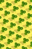 Clover leaf pattern on colored background. Abstract vertical background for St. Patrick's Day photo